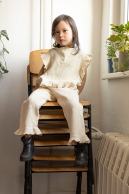 Children’s studio portrait photography with playful movement and modern fashion aesthetics