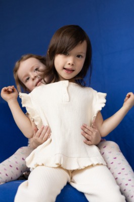 Children’s studio portrait photography with playful movement and modern fashion aesthetics