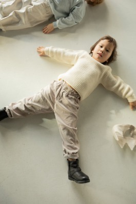 Kidswear fashion portrait in soft studio light, magazine-style cover layout — modern children’s editorial photography. 