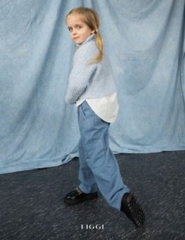 Playful children’s portrait in blue knit sweater and wide-leg pants – soft cinematic kids fashion editorial