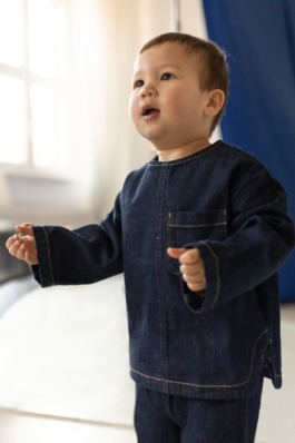 Children’s studio portrait photography with playful movement and modern fashion aesthetics